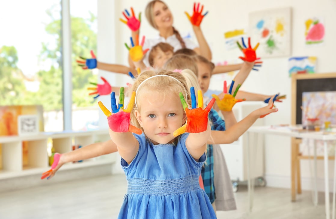 A Preschool Teacher with a Group of Children